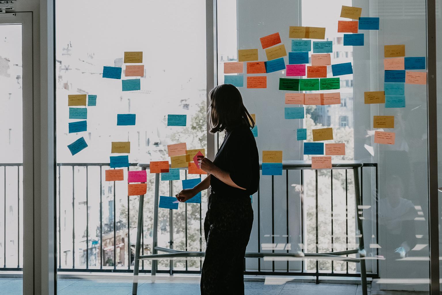 two women working outside on a terrace enjoying the sunlight
